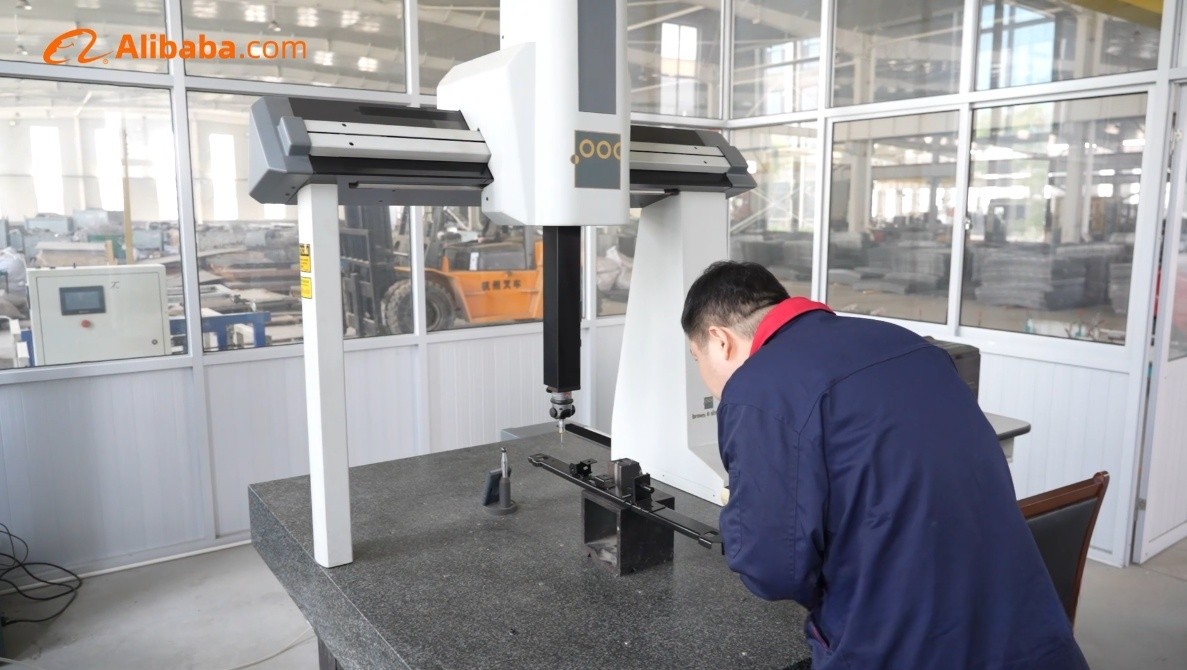 Operator measuring a metal bracket on the coordinate measuring machine at the XCWY quality lab